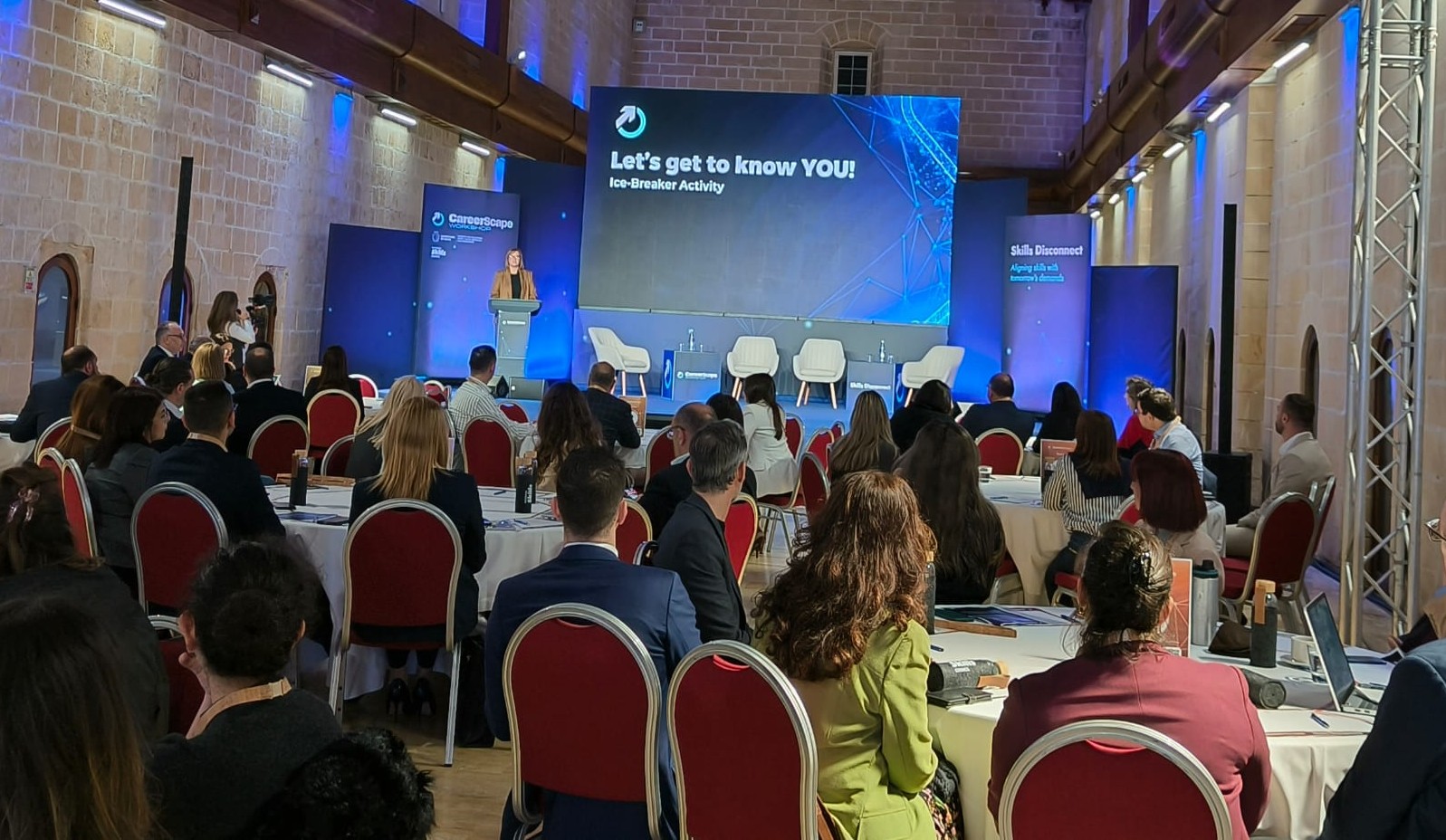 Attendees listening to a speaker
